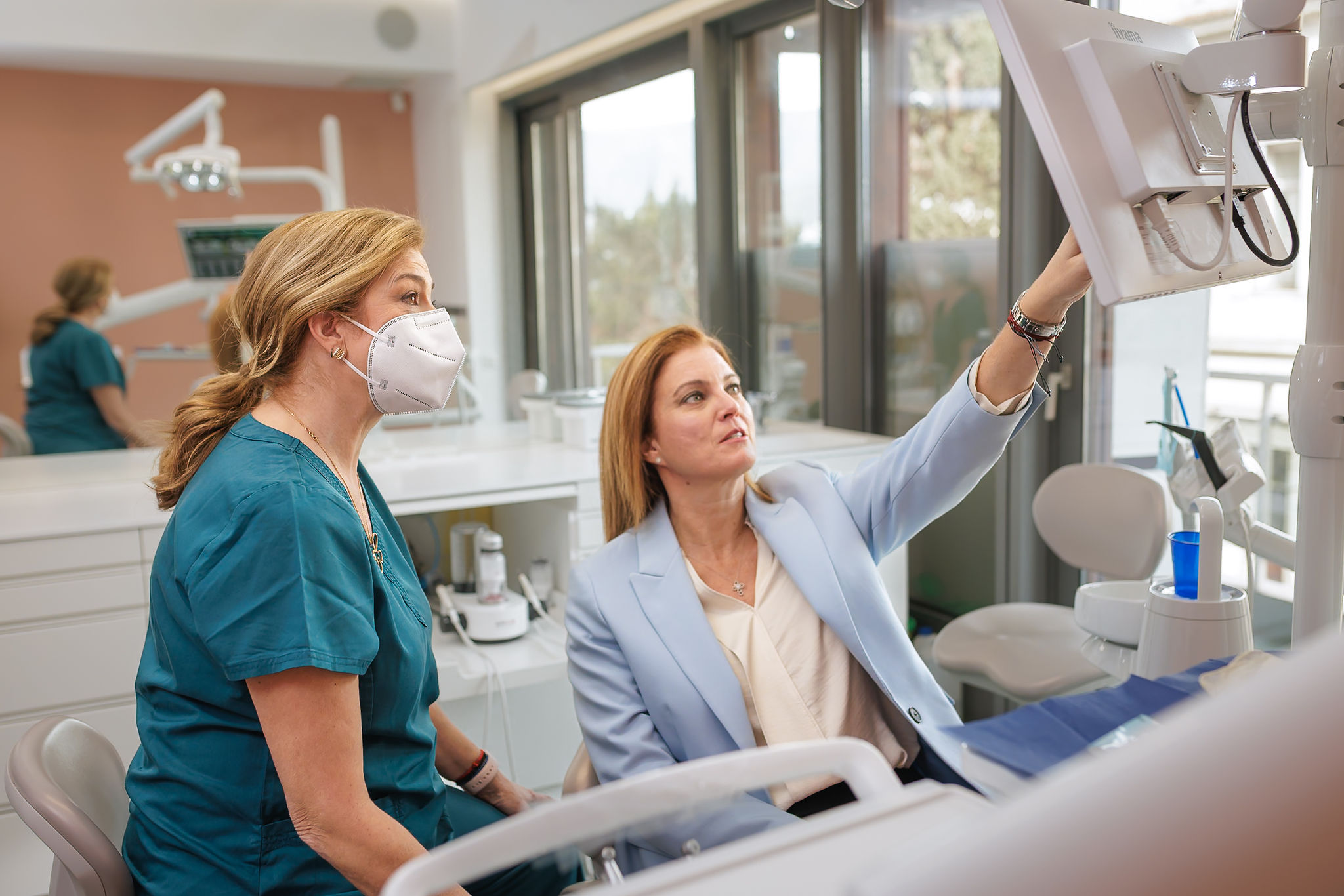 Dr Anna Lagou working with a patient in her dental office
